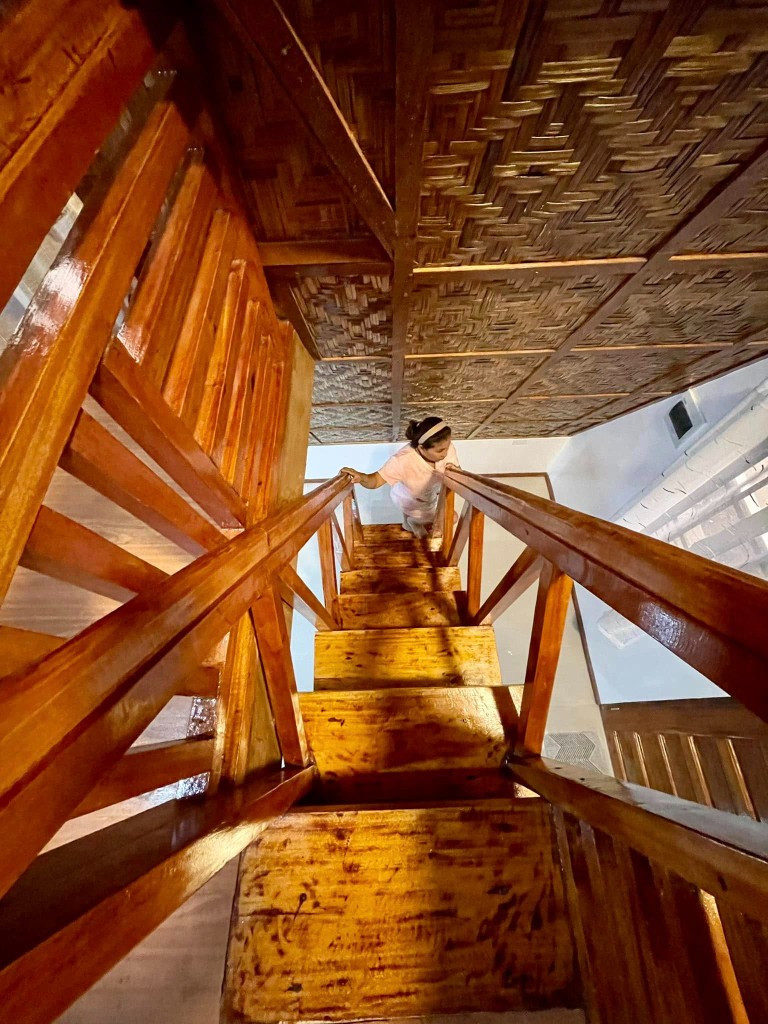 Looking up the handcrafted wooden staircase